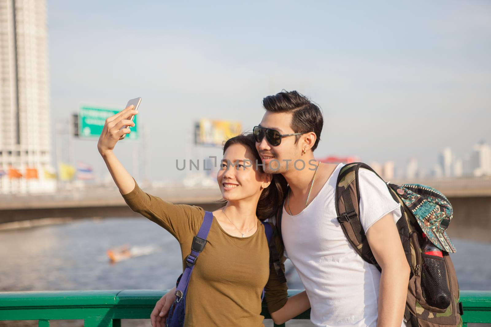 couples of younger man and woman take a selfie photograph by smart phone on traveling location