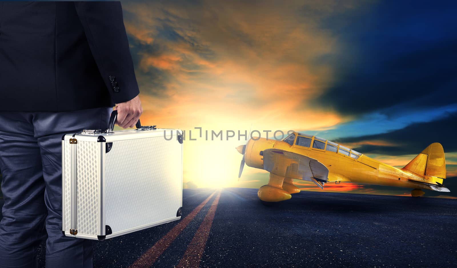 business man with metal strong luggage standing in airport runways with yellow old yellow propeller plane use for air transport and people traveling theme,concept,conception,conceptual,