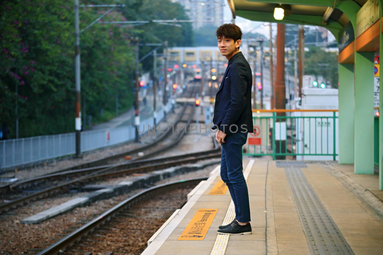 Asia man waiting train at outdoor