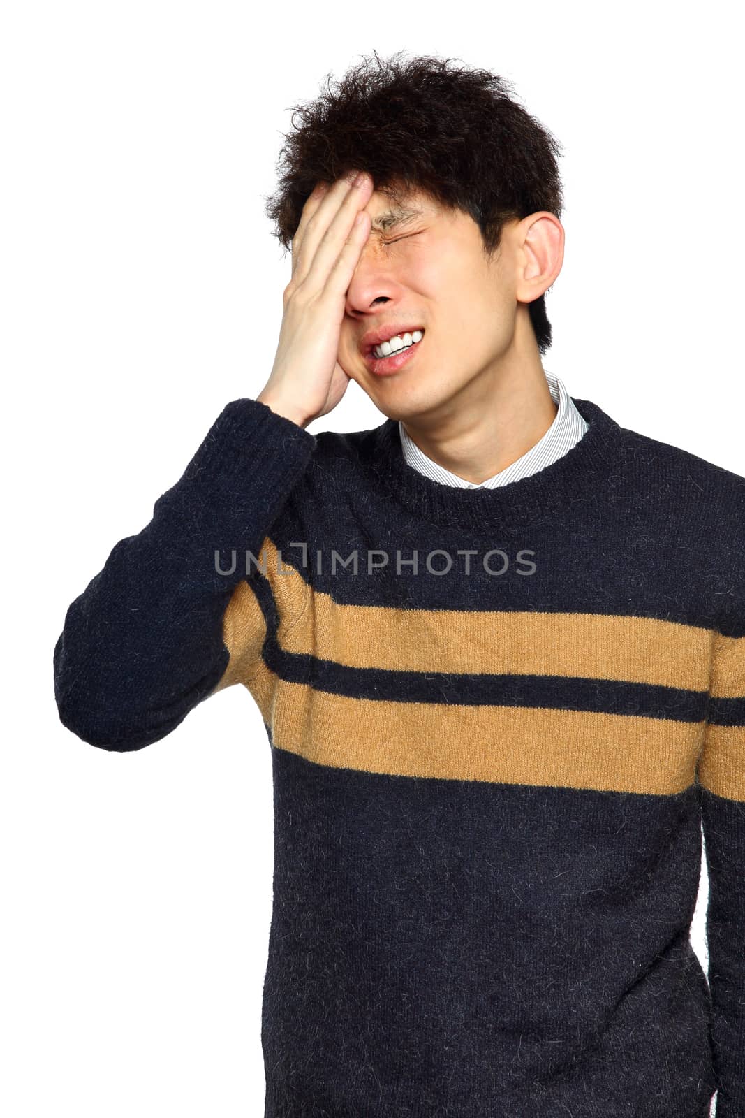 Closeup portrait, stressed young asian man, hands on head with bad headache, isolated background on white. Negative human emotion facial expression feelings.