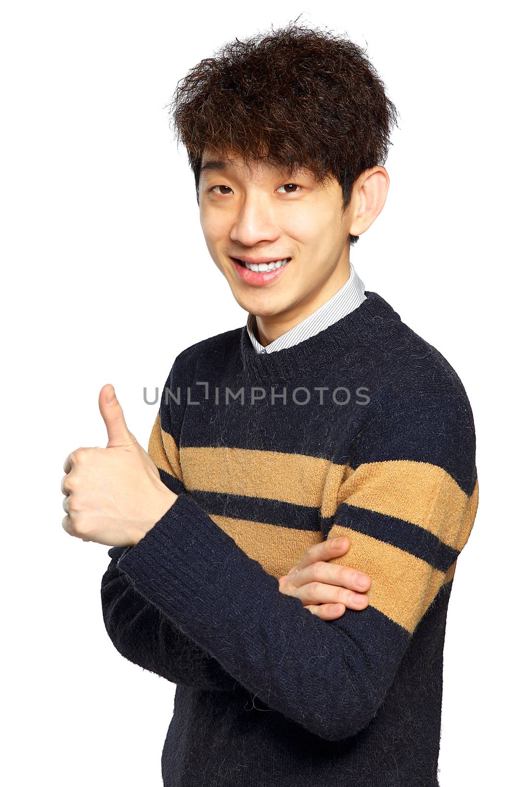 Young laughing asian man showing thumb up hand gesture isolated on white background