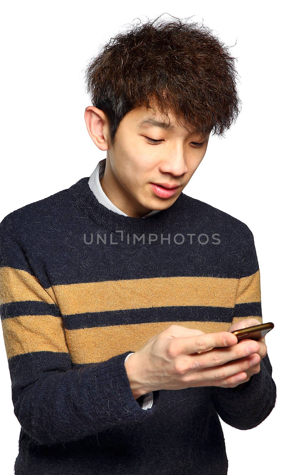 Young man using mobile phone texting by cozyta