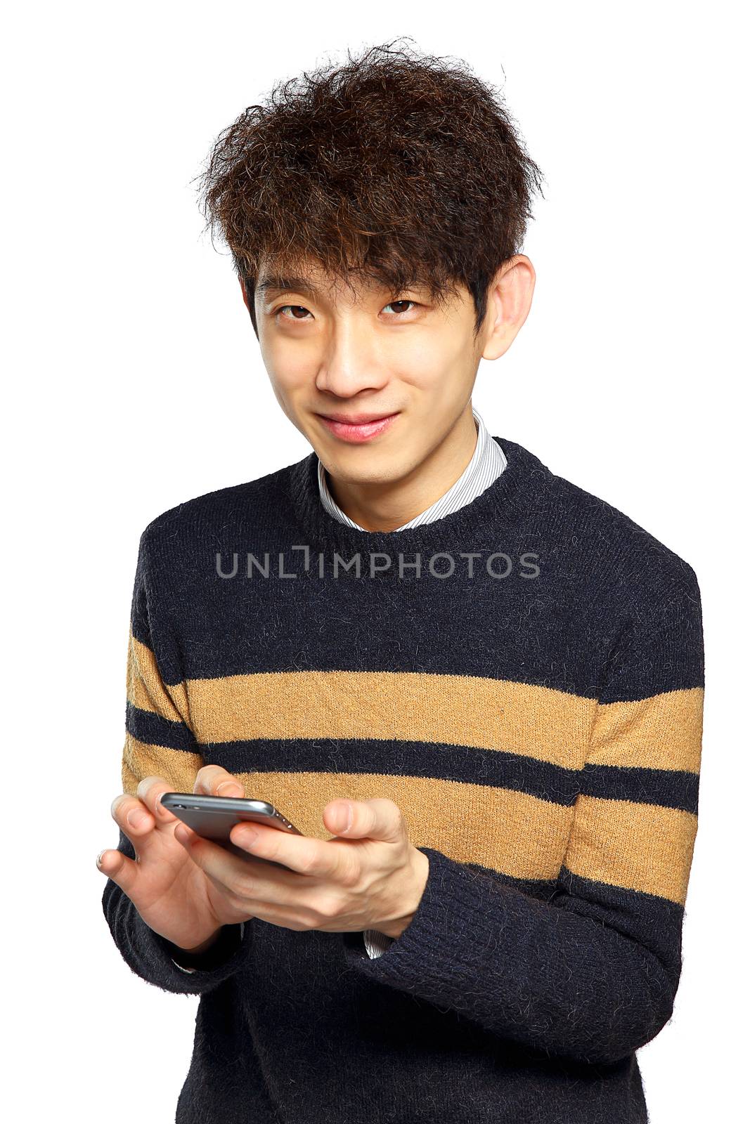 Young man using mobile phone on white background by cozyta