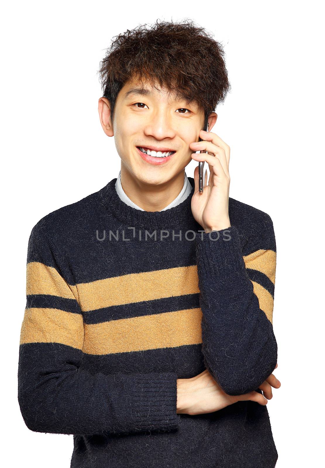 Happy young man talking on mobilephone by cozyta