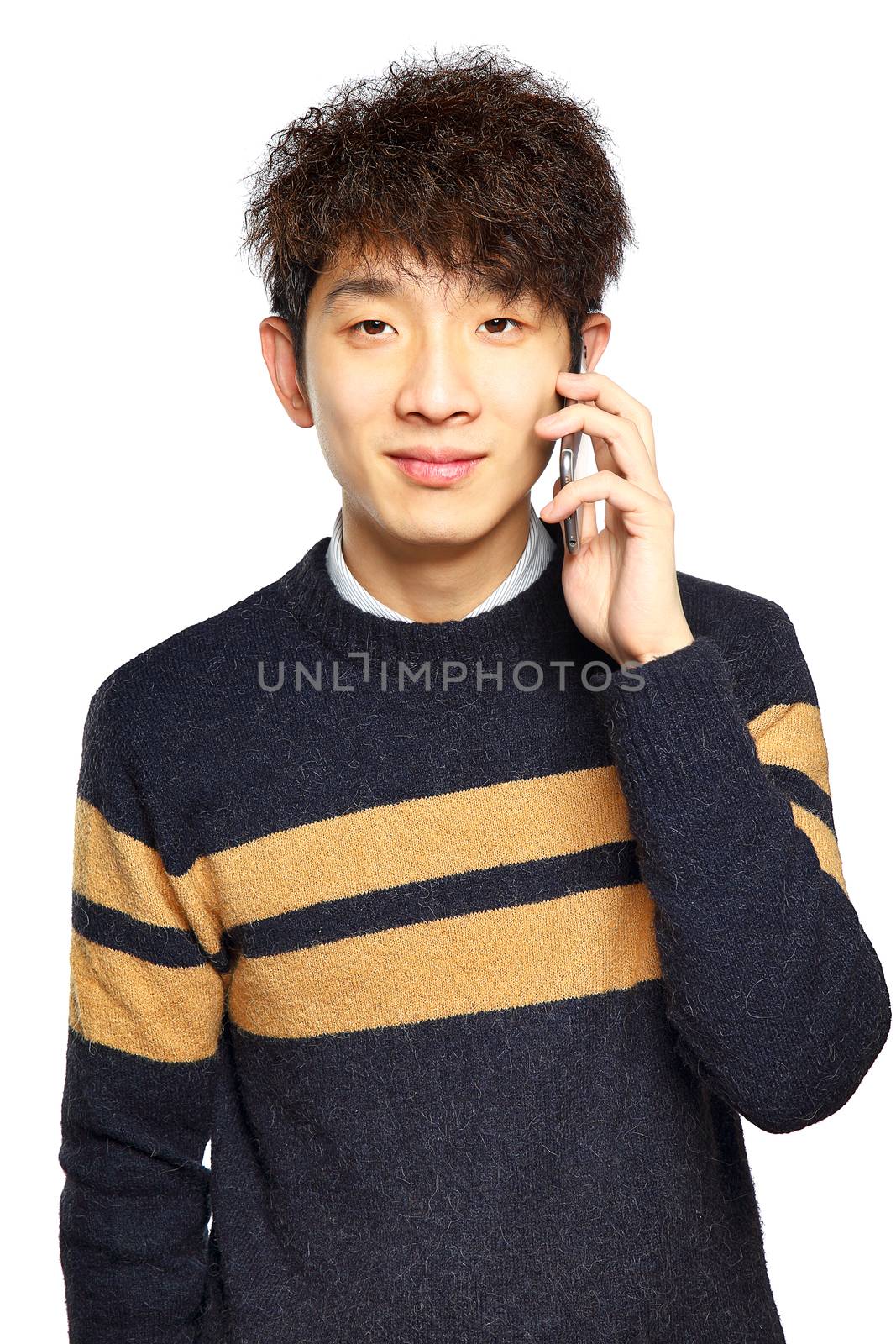 Happy young man talking on mobilephone by cozyta