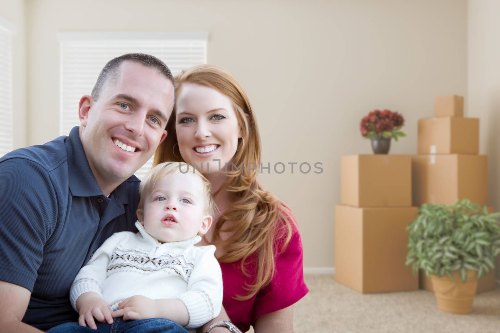 Young Military Family in Empty Room with Packed Boxes by Feverpitched