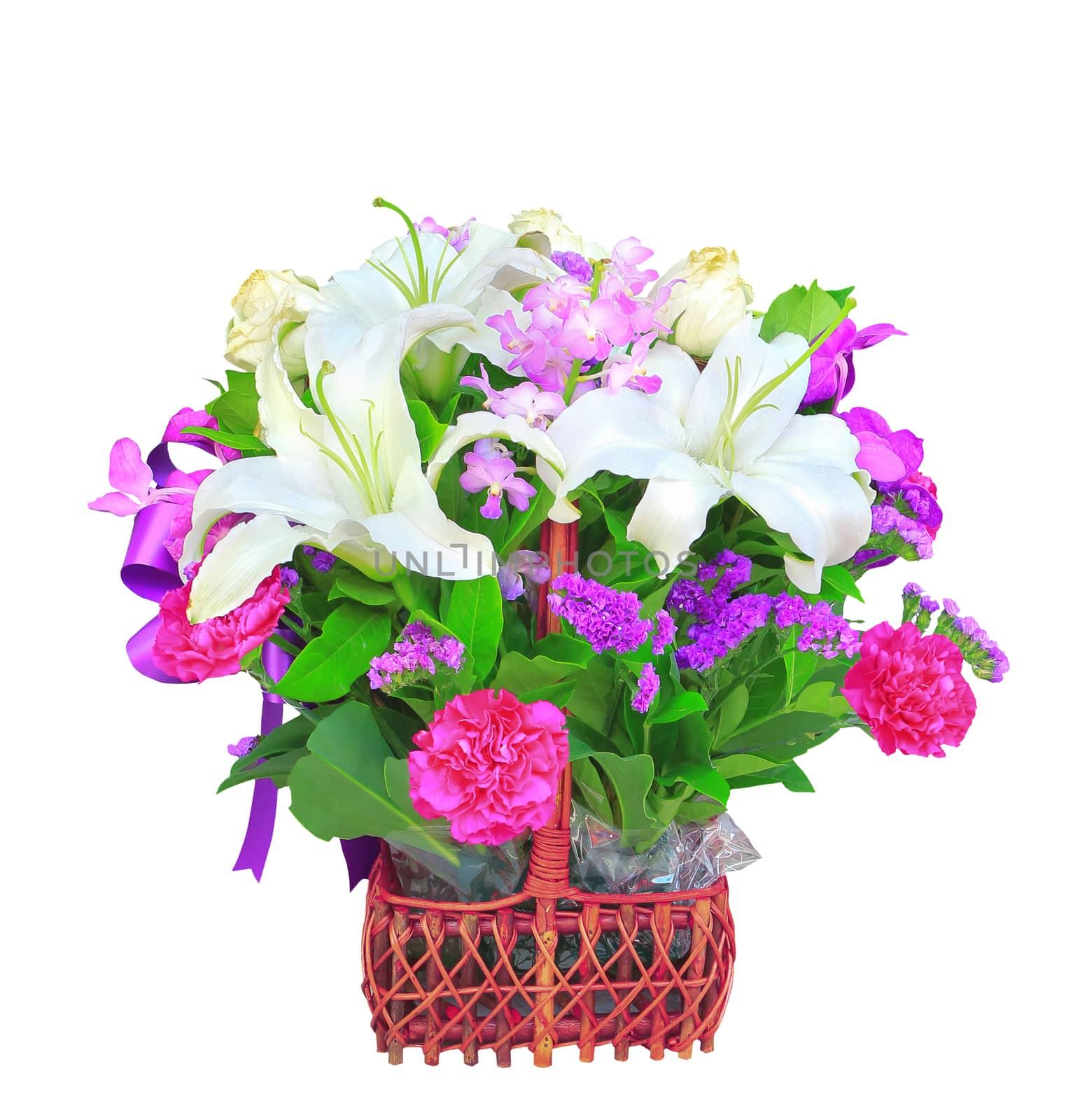 white lily flower bouquet decorated with tropical orchid and green leaves in rattan bucket isolated white background