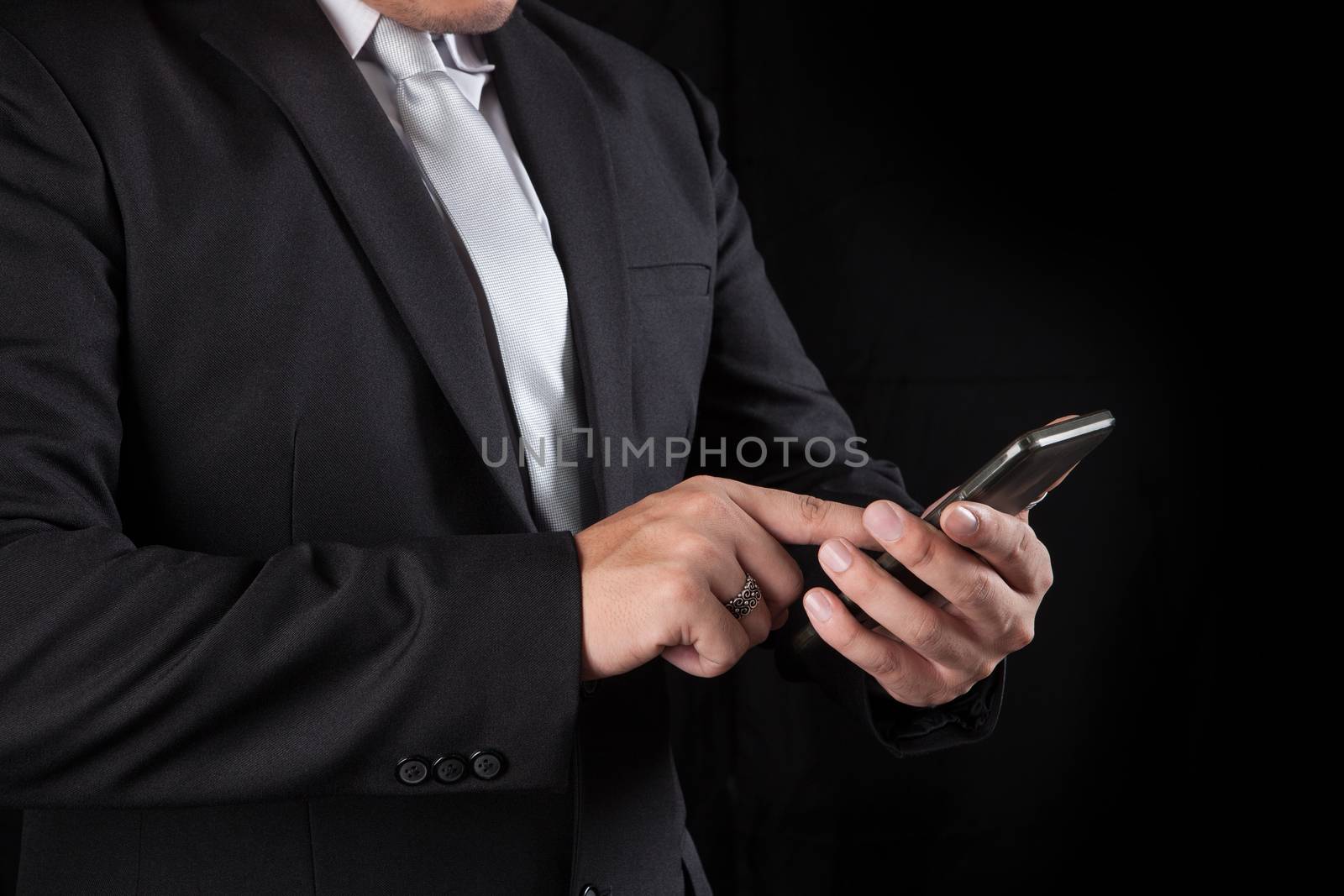 business man touching on mobile phone screen use for connecting in modern lifestyle digital technology