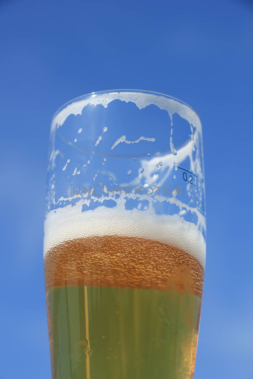 Glass of beer on a sunny summer day, blue sky
