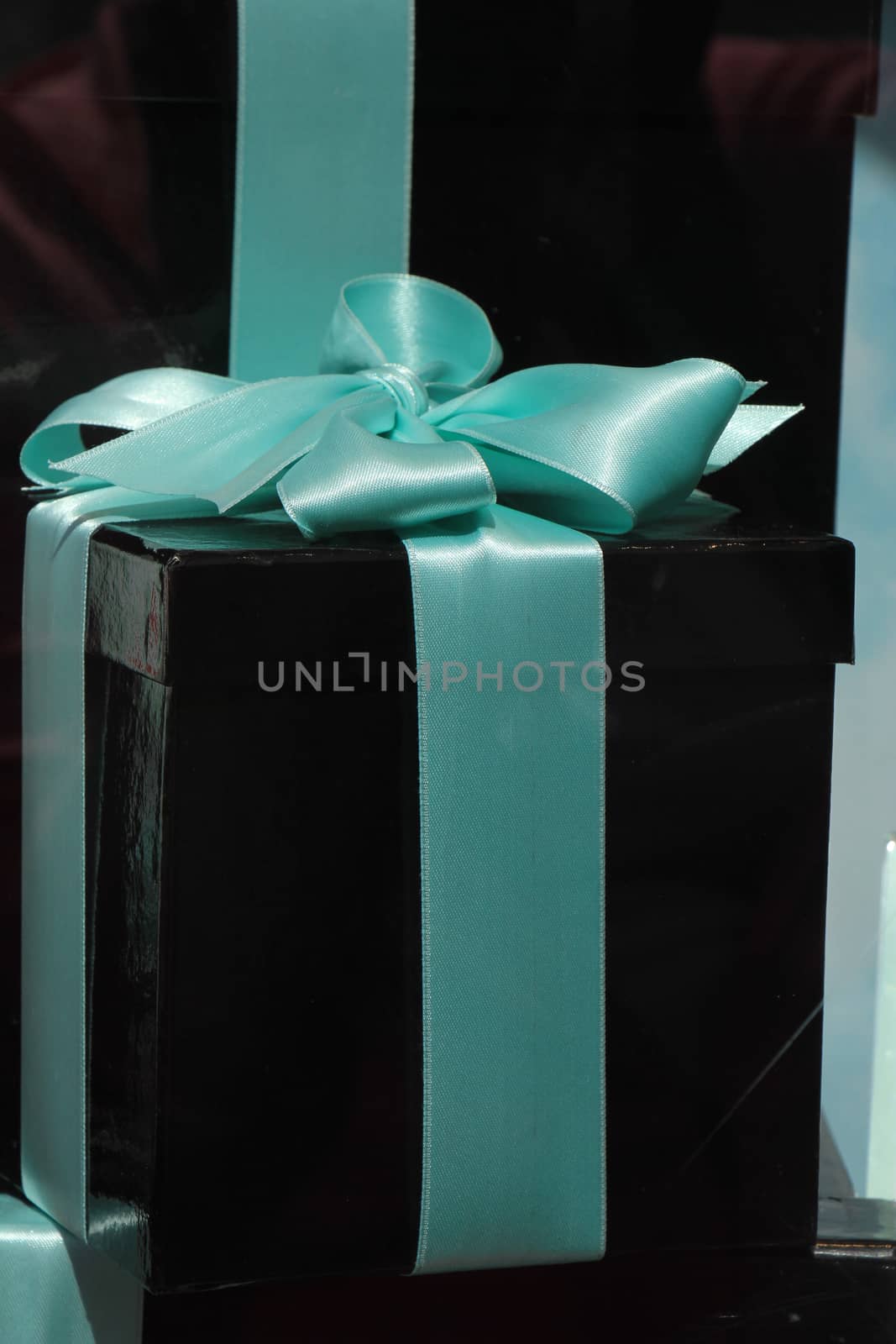 Black gift box with a blue satin bow