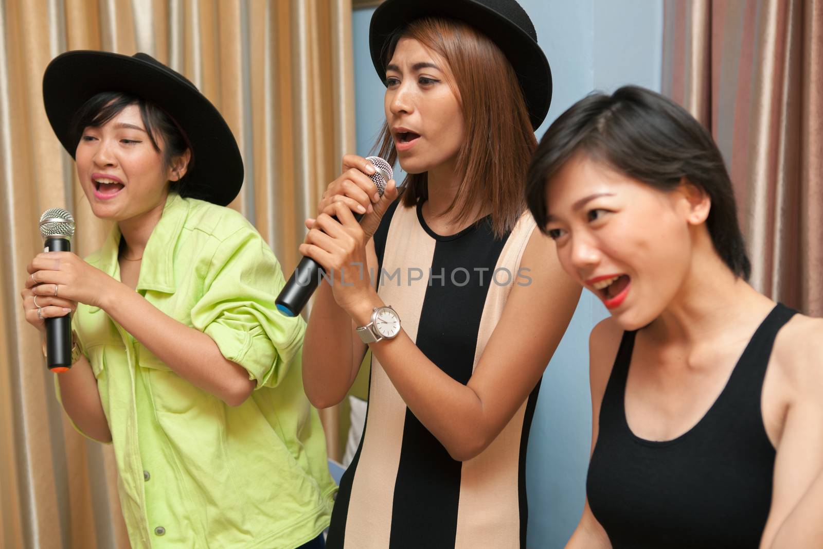 portrait asain woman friend group relaxing emotion by singing and song with happyiness emotion in karaoke entertainment room 