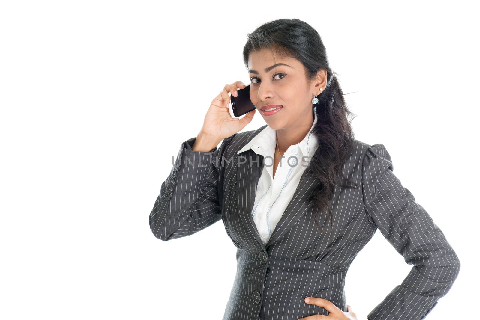 Black business woman calling on smartphone, looking at camera, isolated on white background.