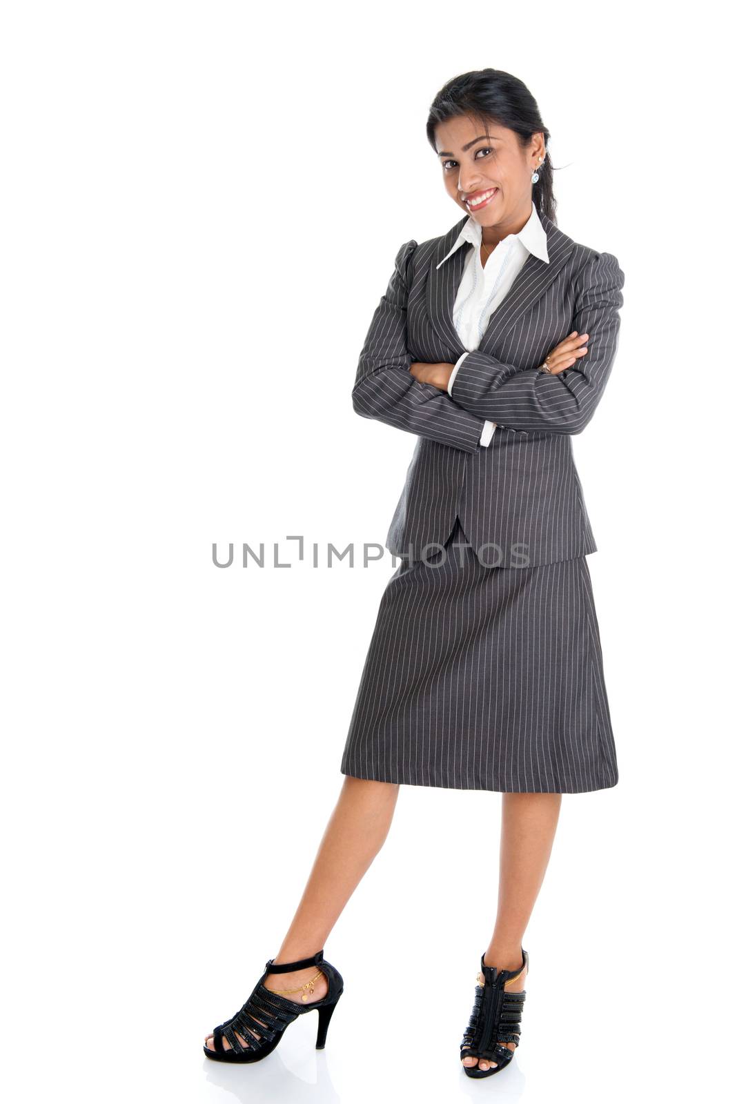 Full length portrait of African American businesswoman standing arms crossed isolated on white background. 