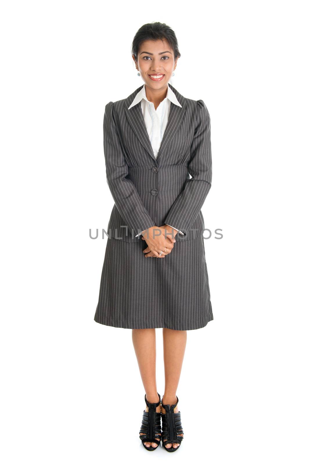 Full length portrait of Indian businesswoman standing isolated on white background. Mixed race Asian Indian and African American model.