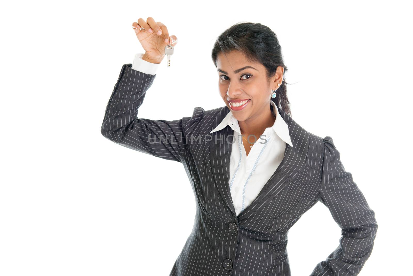 Realtor hand holding house key and smiling, isolated on white background.