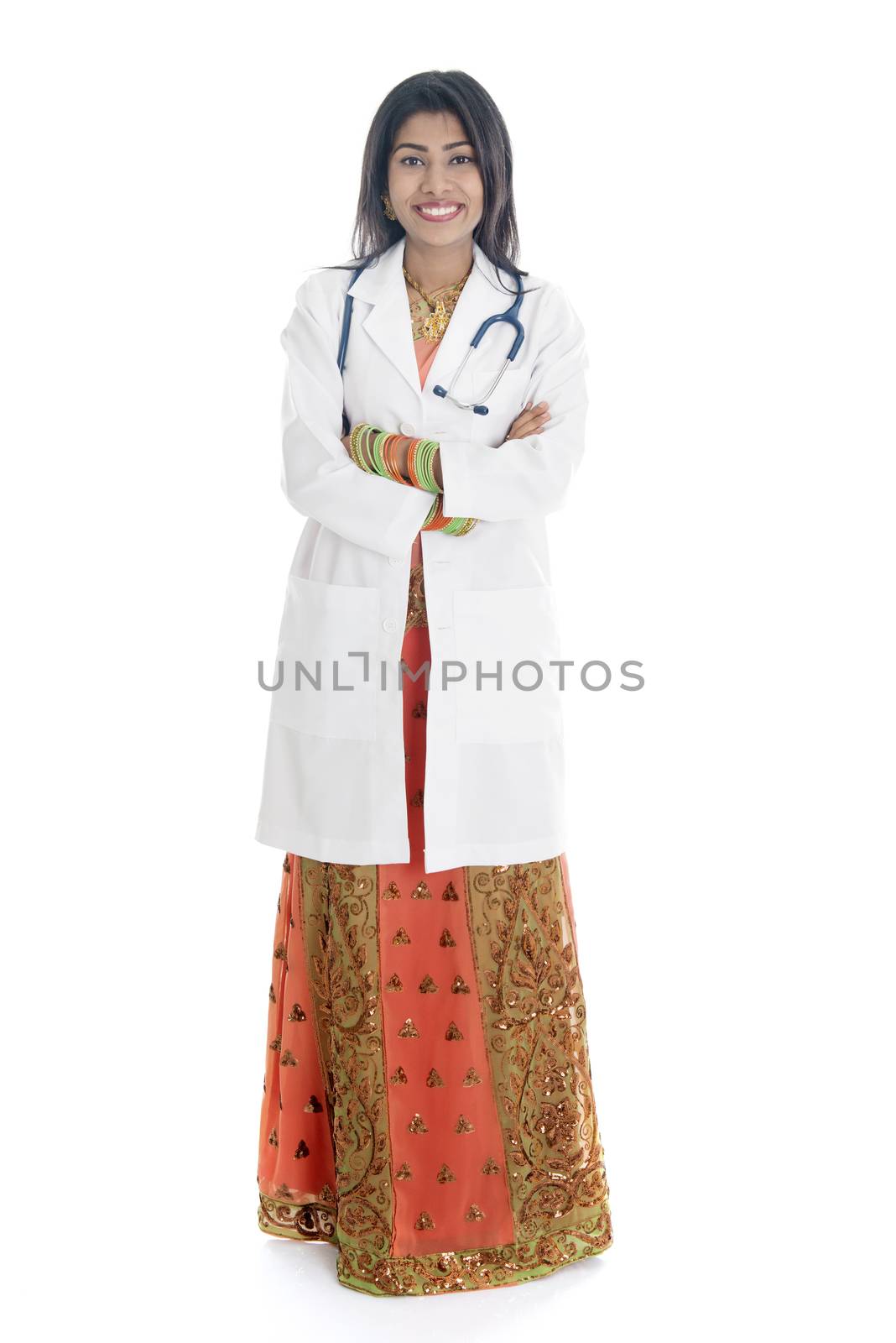 Portrait of full length Indian female medical doctor standing isolated on white background.