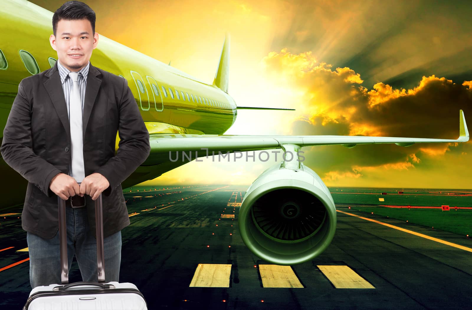 young business man and traveling luggage standing in front of passenger jet plane flying over airport runways use for people journey and air transport occupation