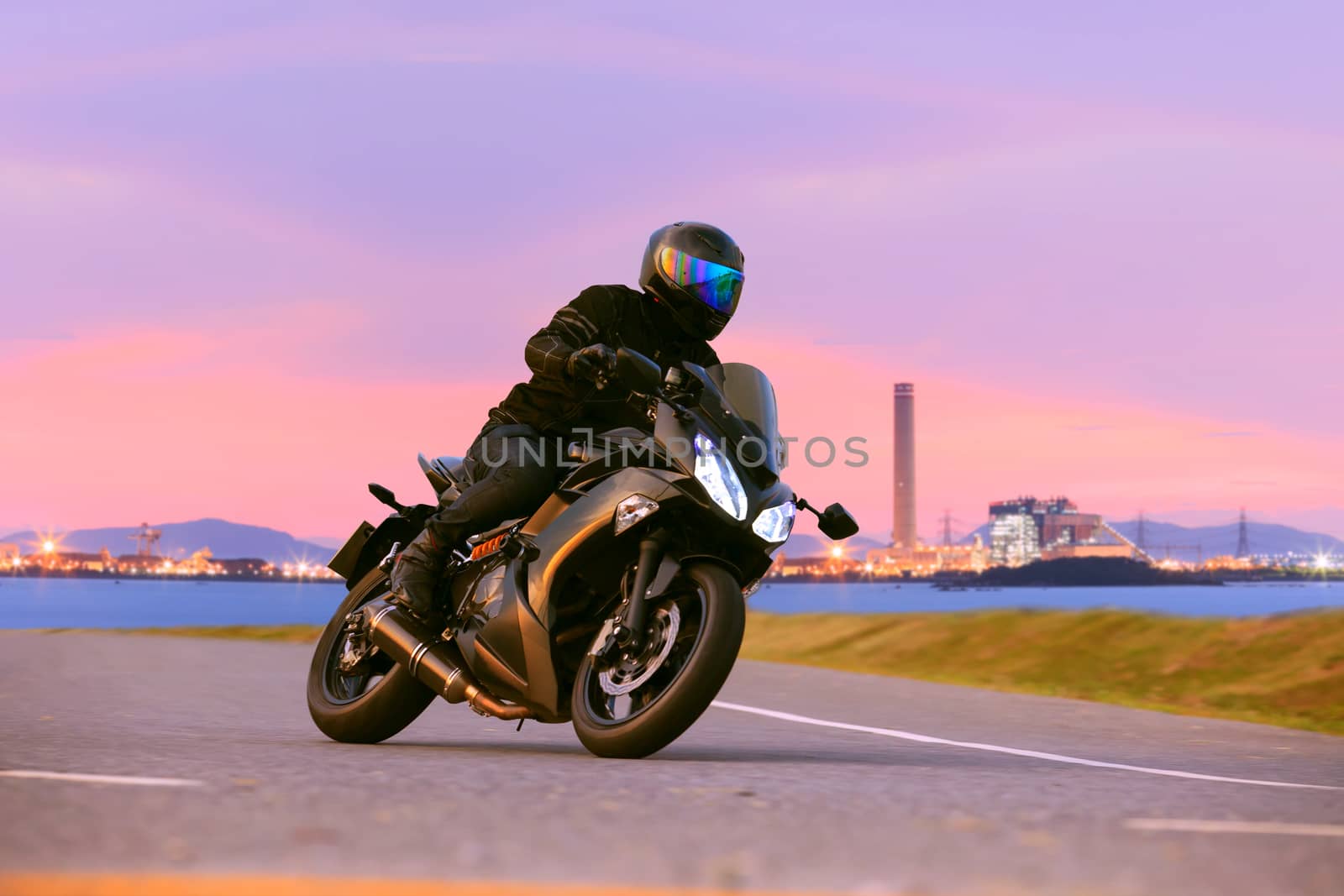 young man riding sport touring motorcycle on asphalt highways ag by khunaspix