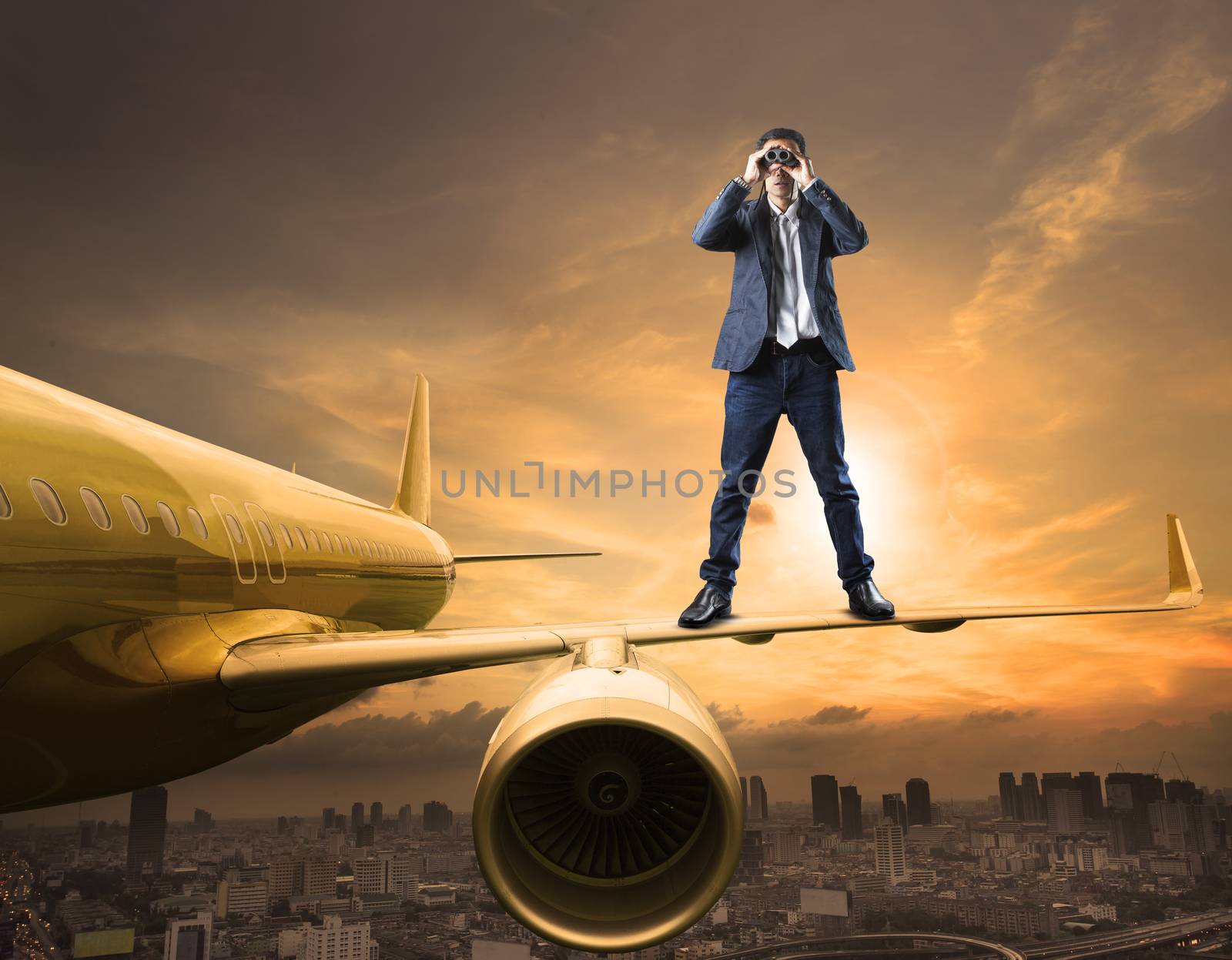 business man and binoculars lens standing on plane wing spying acting use for commercial competition and top secret strategy 