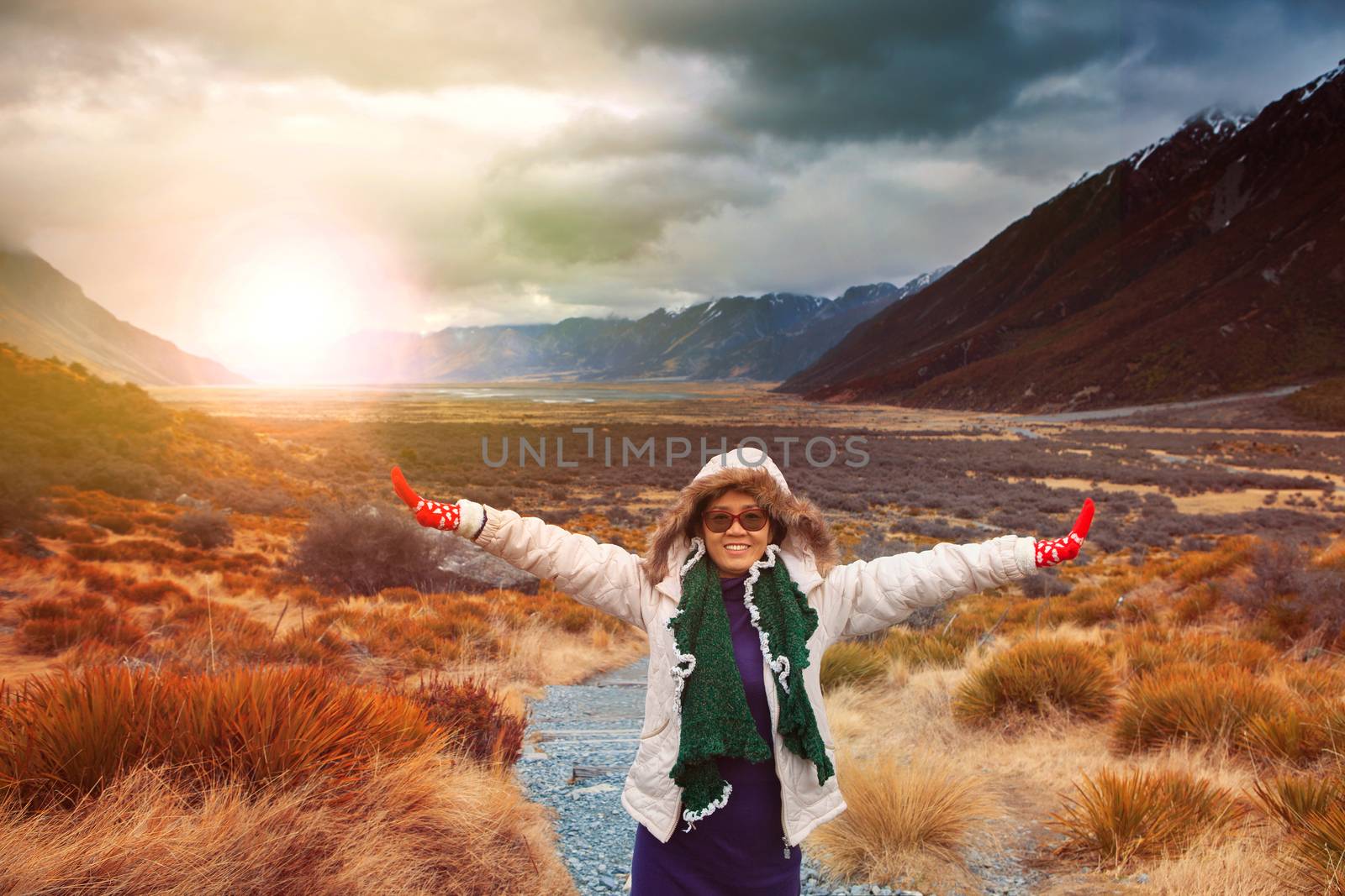 woman traveler wearing winter clothes take a photo with happiness emotion in sun rise natural mountain scene 