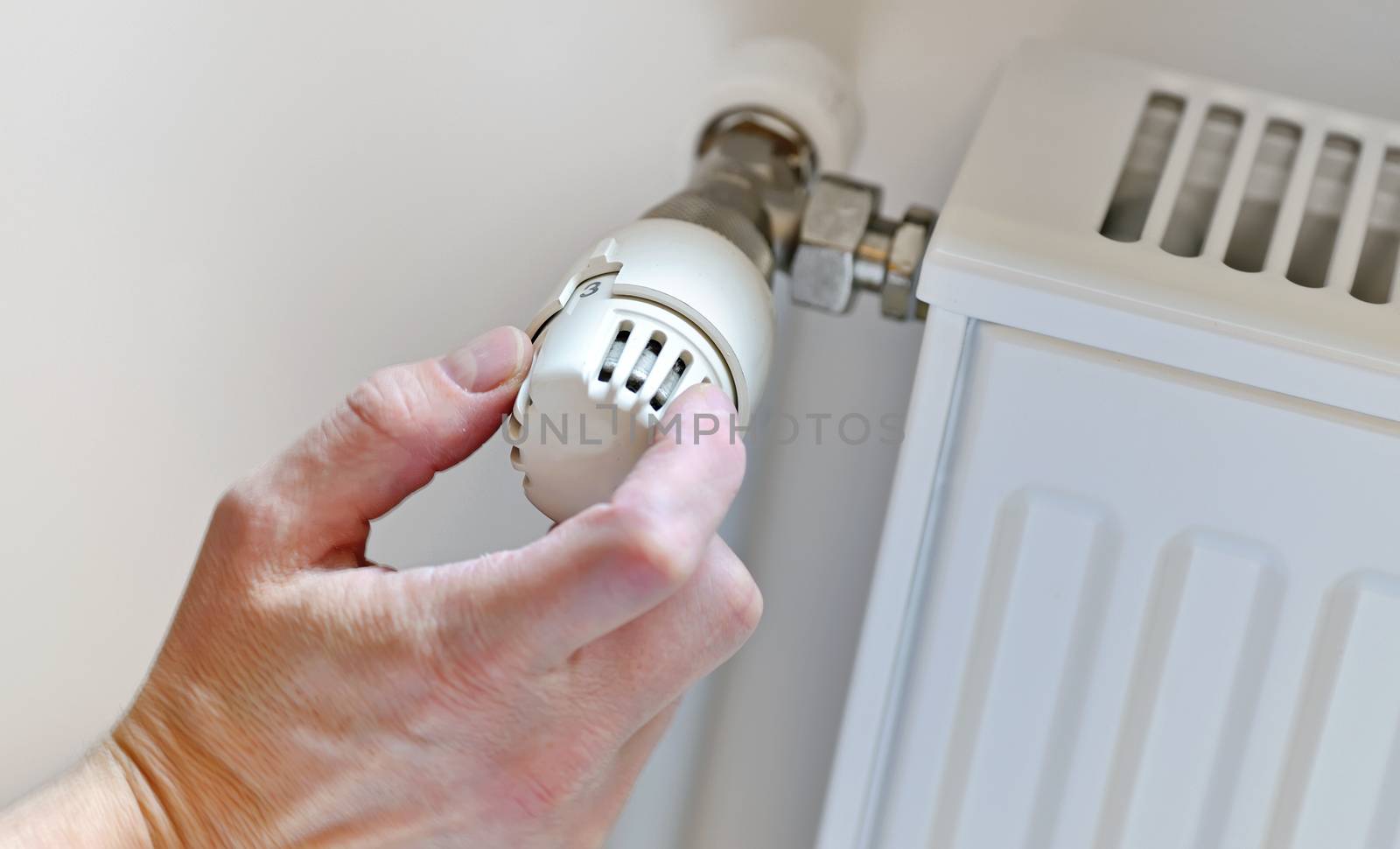  Hand Adjusting Heater Thermostat in winter time