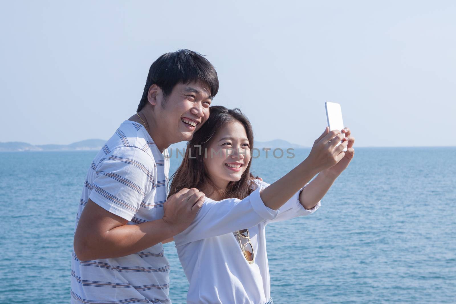 portrait of young man and woman selfie ,self portrait by mobile phone in relaxing emotion sea beach destination use for people in modern life style