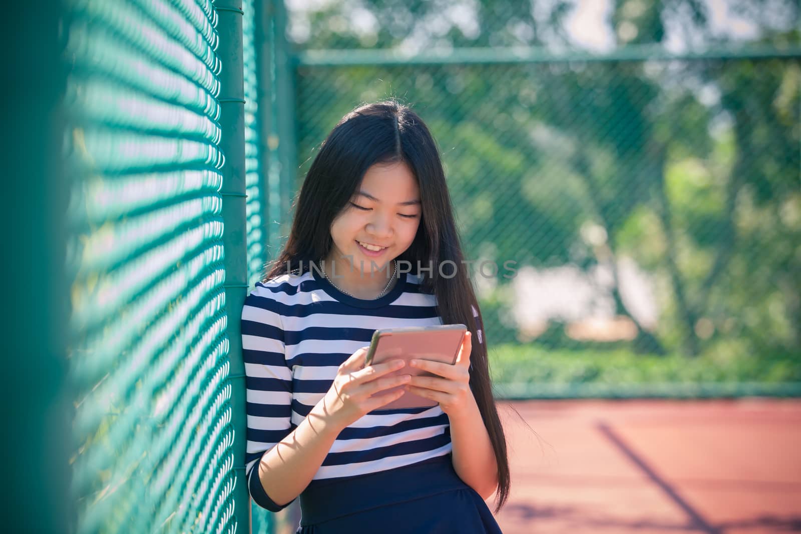 asian girl and computer tablet in hand standing with toothy smiling face use for people and internet connecting ,communication in modern digital lifestyle