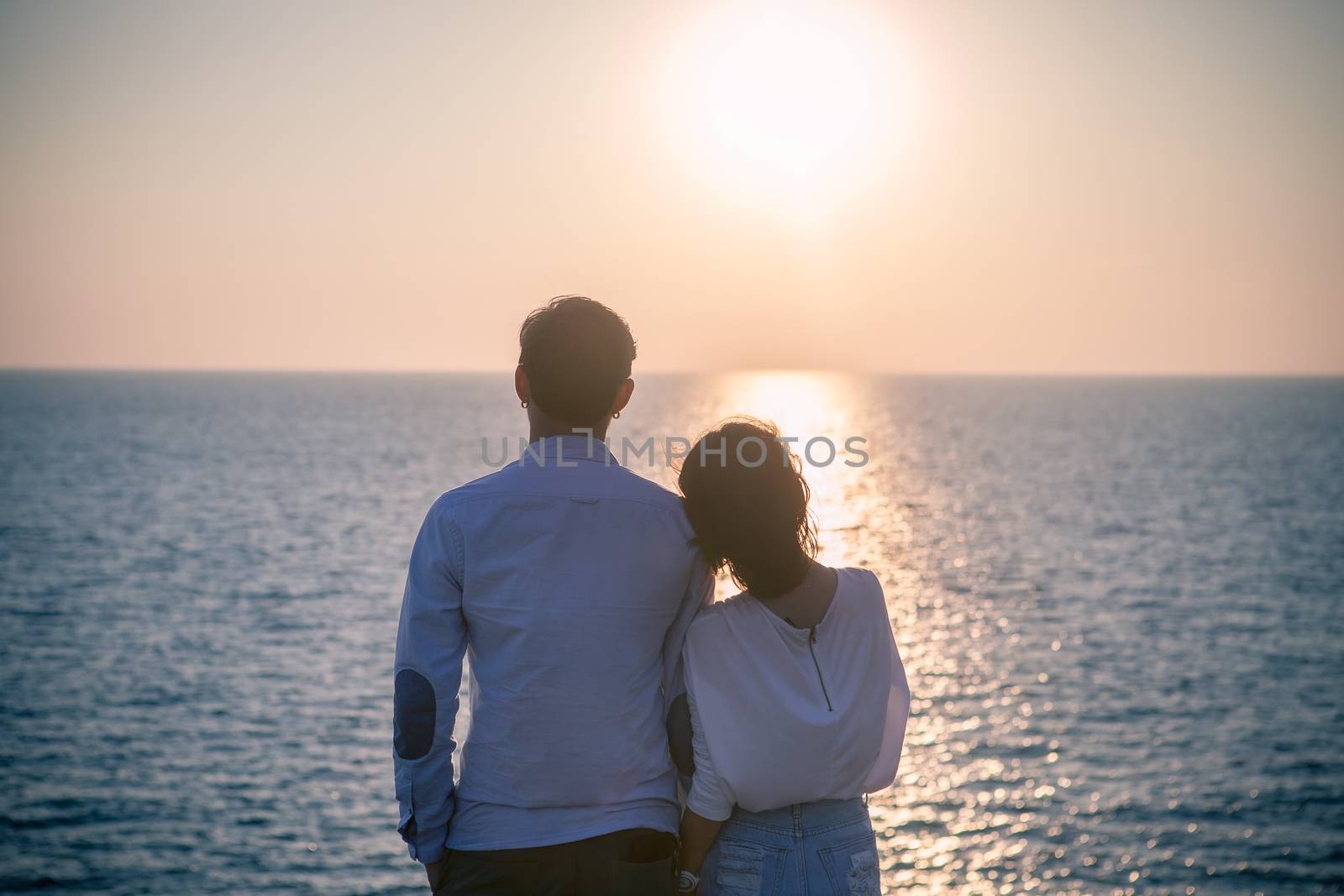 hipster photography style of younger love couples vacation relaxing with sun set sky at destination sea side happiness emotion