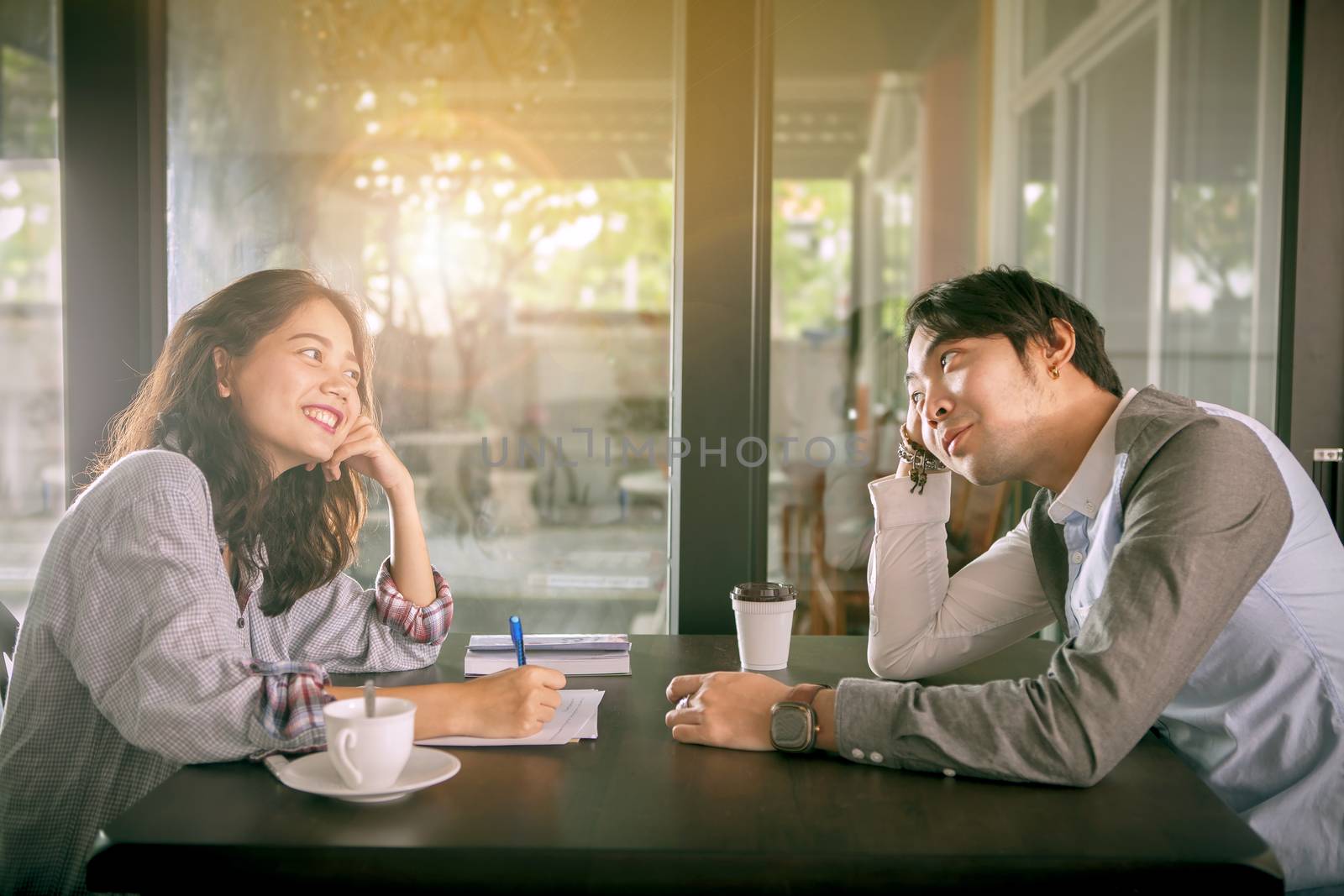 couples of younger asian man and woman relaxing with hot coffee  by khunaspix
