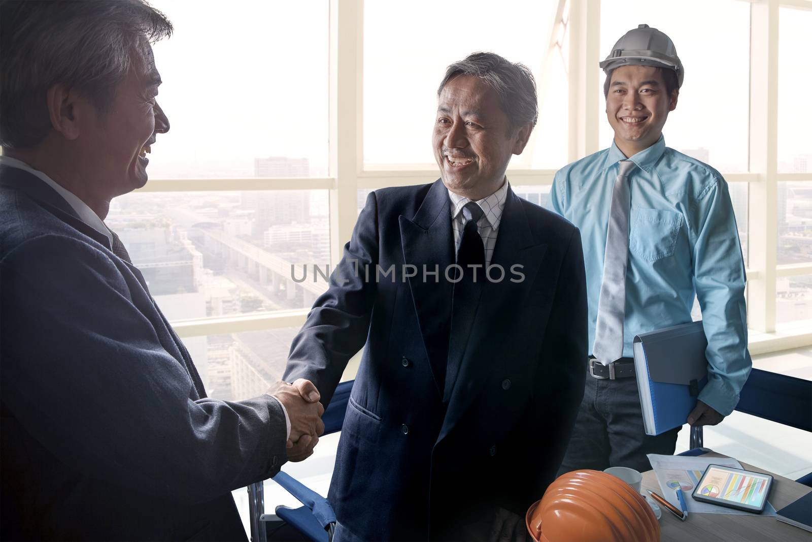 business man shaking hand after successful project solution plan by khunaspix