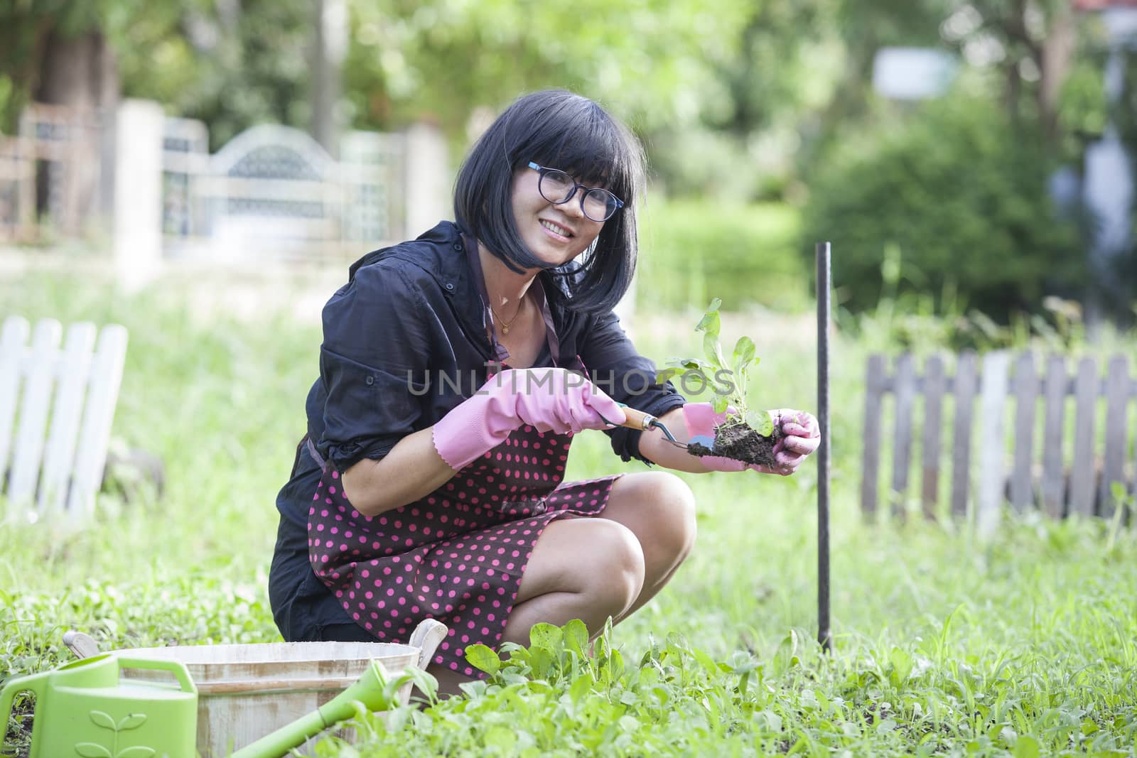 asian woman relaxing happiness emotion planting organic vegetable in home garden
