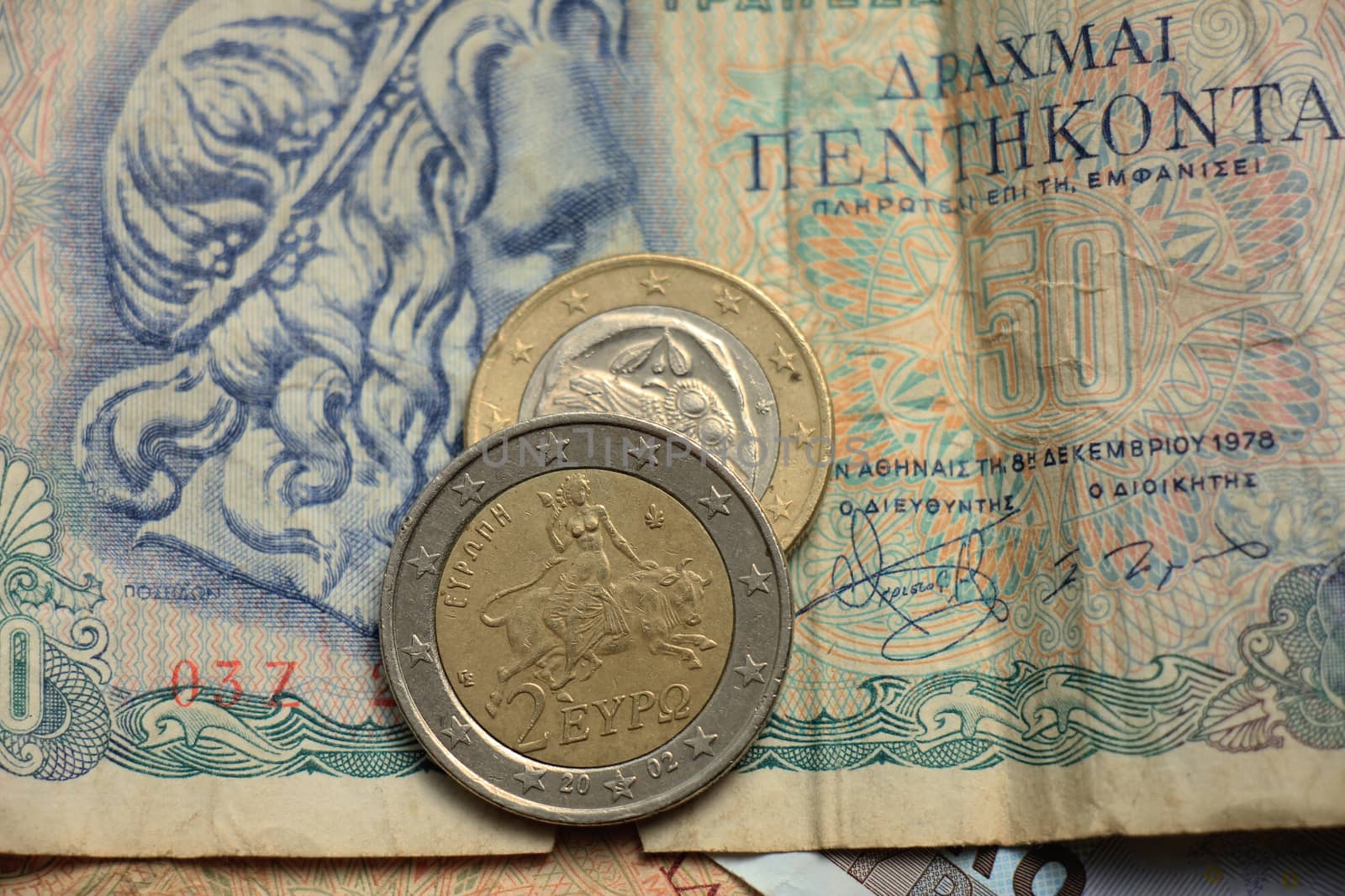 Greek euro coins on a vintage greek bank note