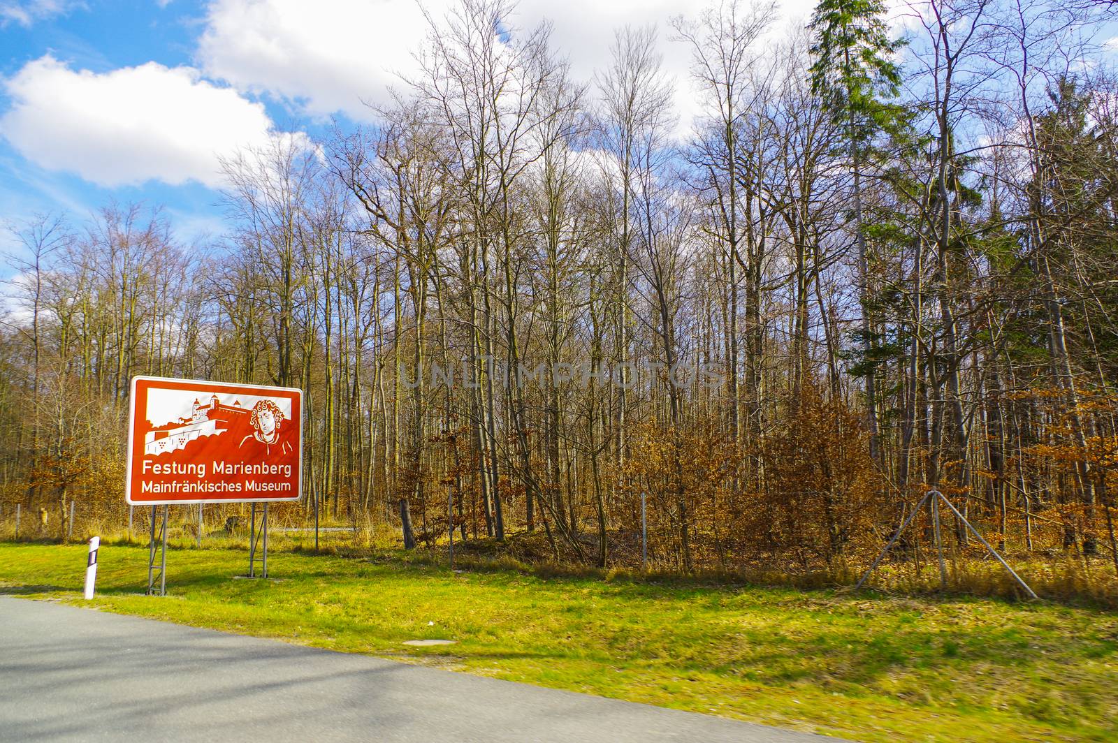 a red highway sign with a ilustration of historic place in Bavaria, Germany, part of the UNESCO World Heritage Site - Residenz Wuerzburg UNESCO Kulturerbe - in German