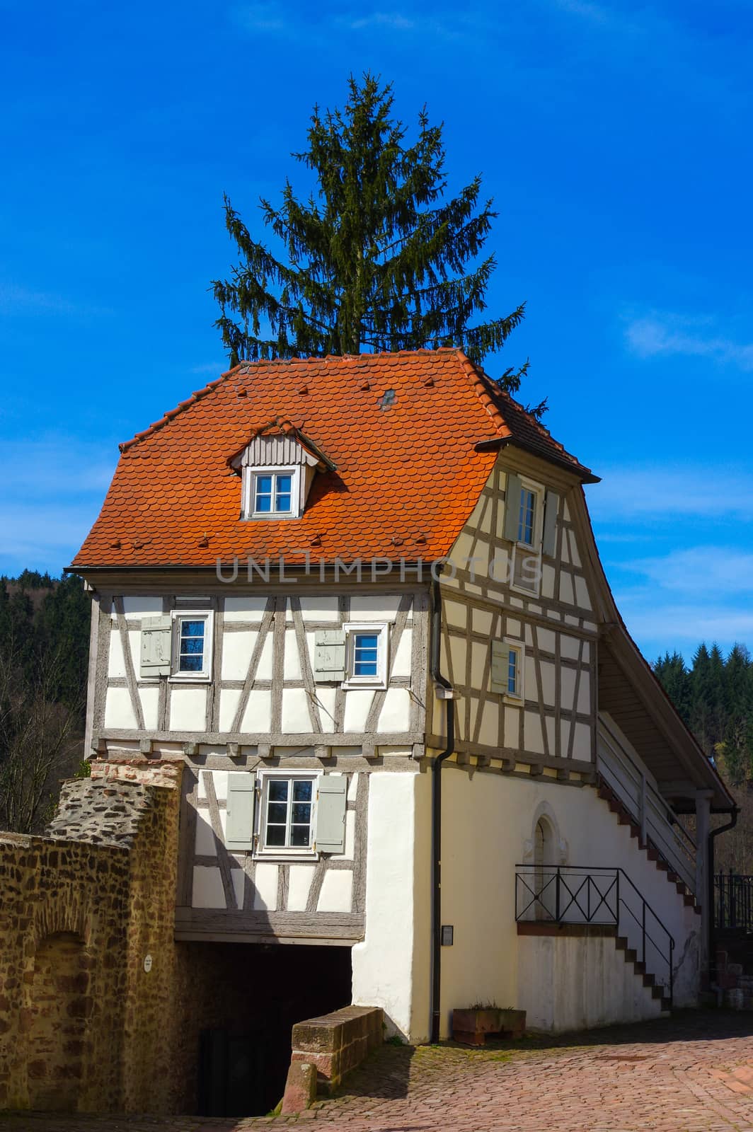 Residential tudor style house with blue sky in background by evolutionnow