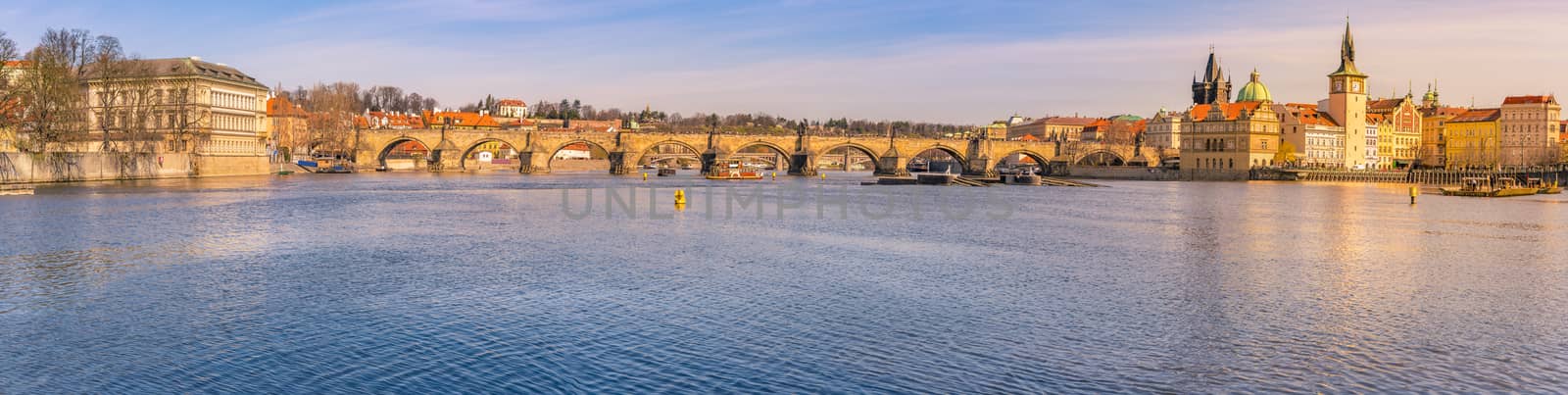 Cityscape with the Charles Bridge, the Vltava river and the historical buildings from Prague, the capital of Czech Republic, on a sunny day of March.