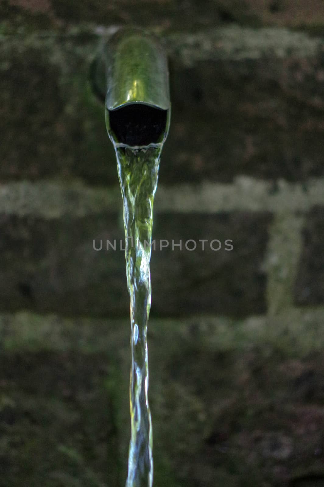 Close up of running water from a metal tap by evolutionnow