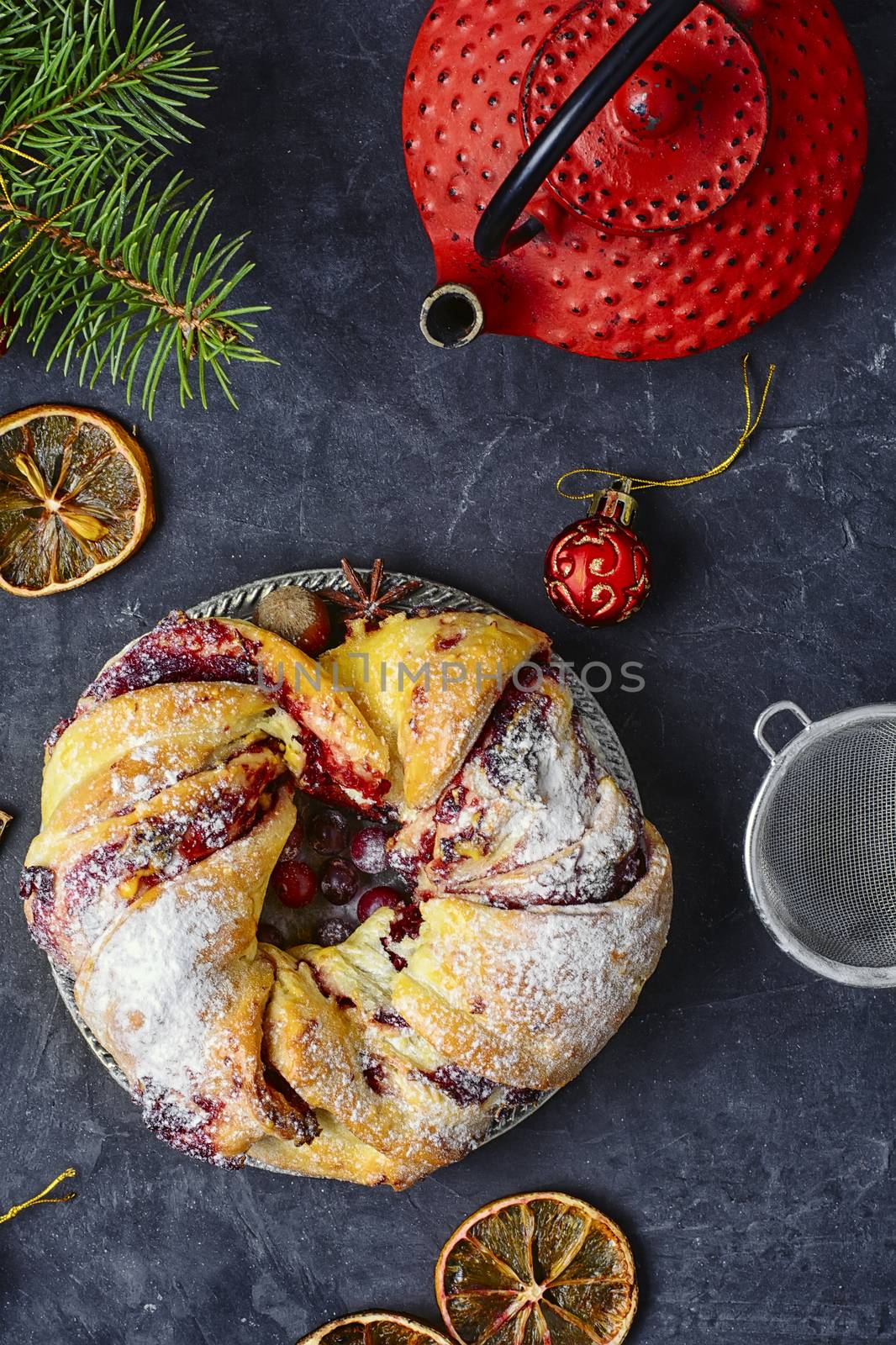 Christmas cookies on platter,red stylish kettle and spruce branch
