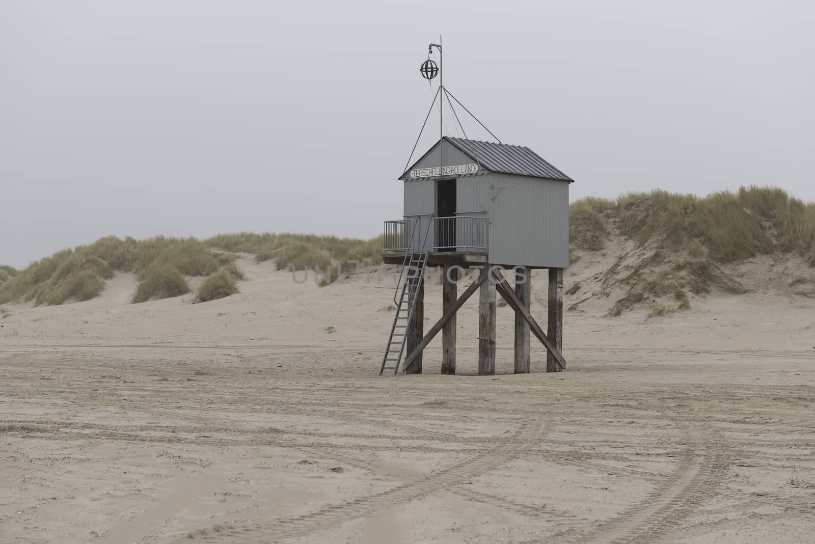 The sea cottage of Terschelling is from the end of 2015 posted near pole 24 on the North Sea Beach at the dunes on a larger and more secure distance from the North Sea on a new location. Picture was taken on a foggy and drizzly autumn day
