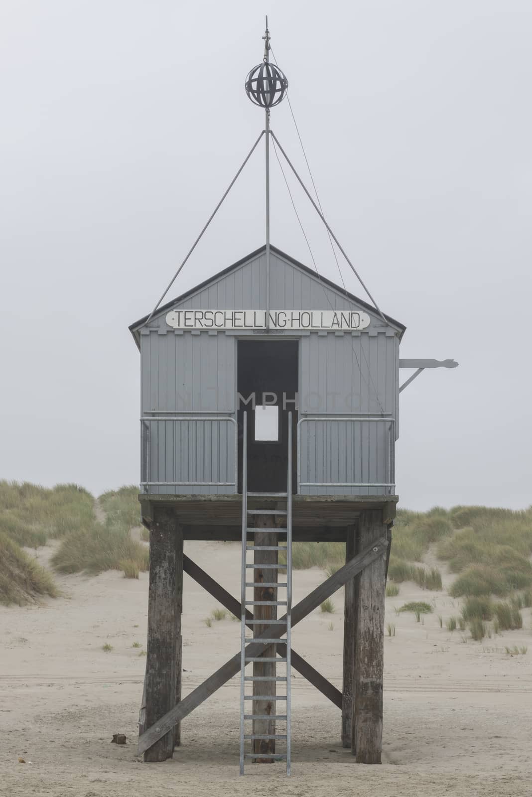 The sea cottage of Terschelling is from the end of 2015 posted near pole 24 on the North Sea Beach at the dunes on a larger and more secure distance from the North Sea on a new location. Picture was taken on a foggy and drizzly autumn day
