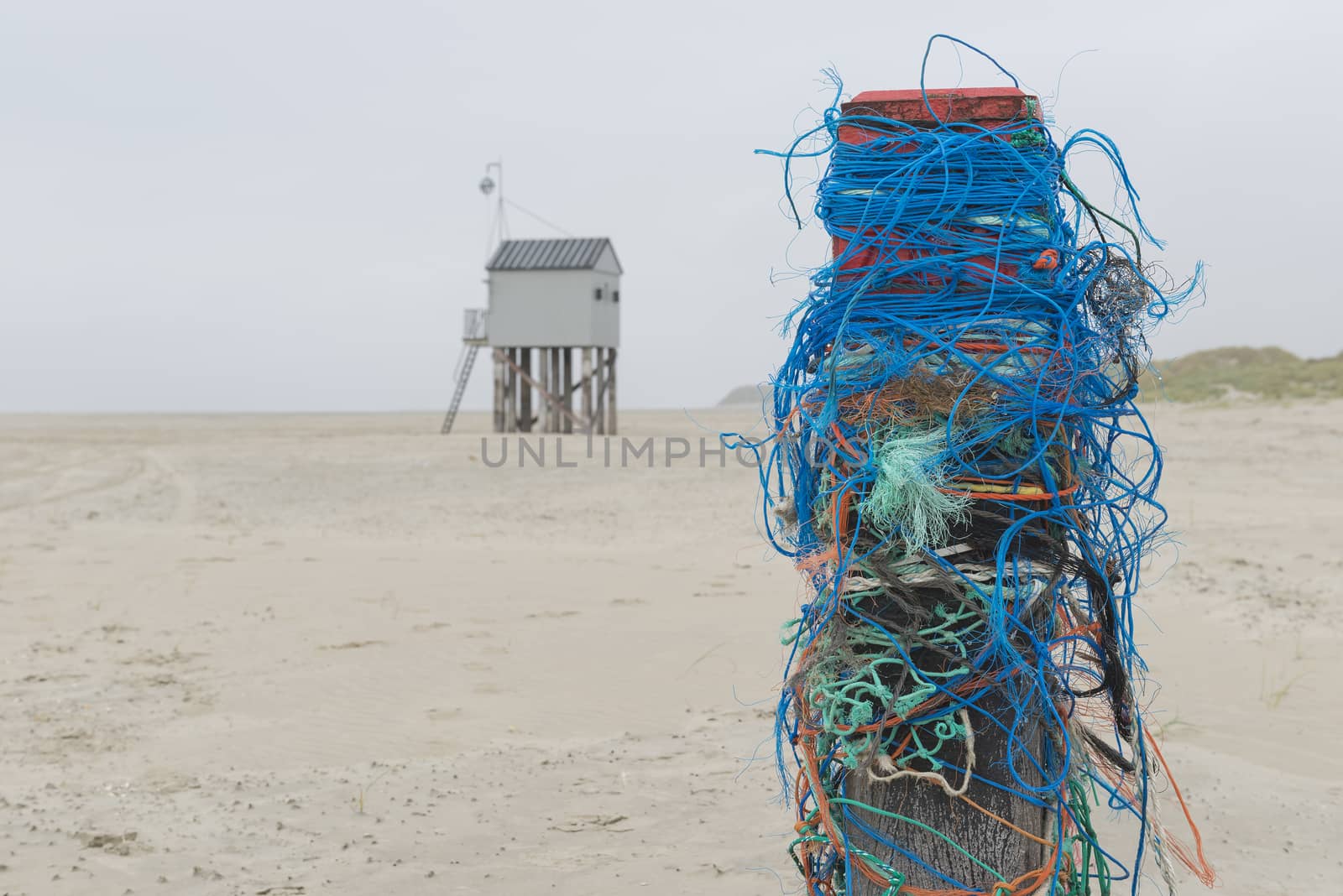 The sea cottage of Terschelling is from the end of 2015 posted near pole 24 on the North Sea Beach at the dunes on a larger and more secure distance from the North Sea on a new location. Picture was taken on a foggy and drizzly autumn day
