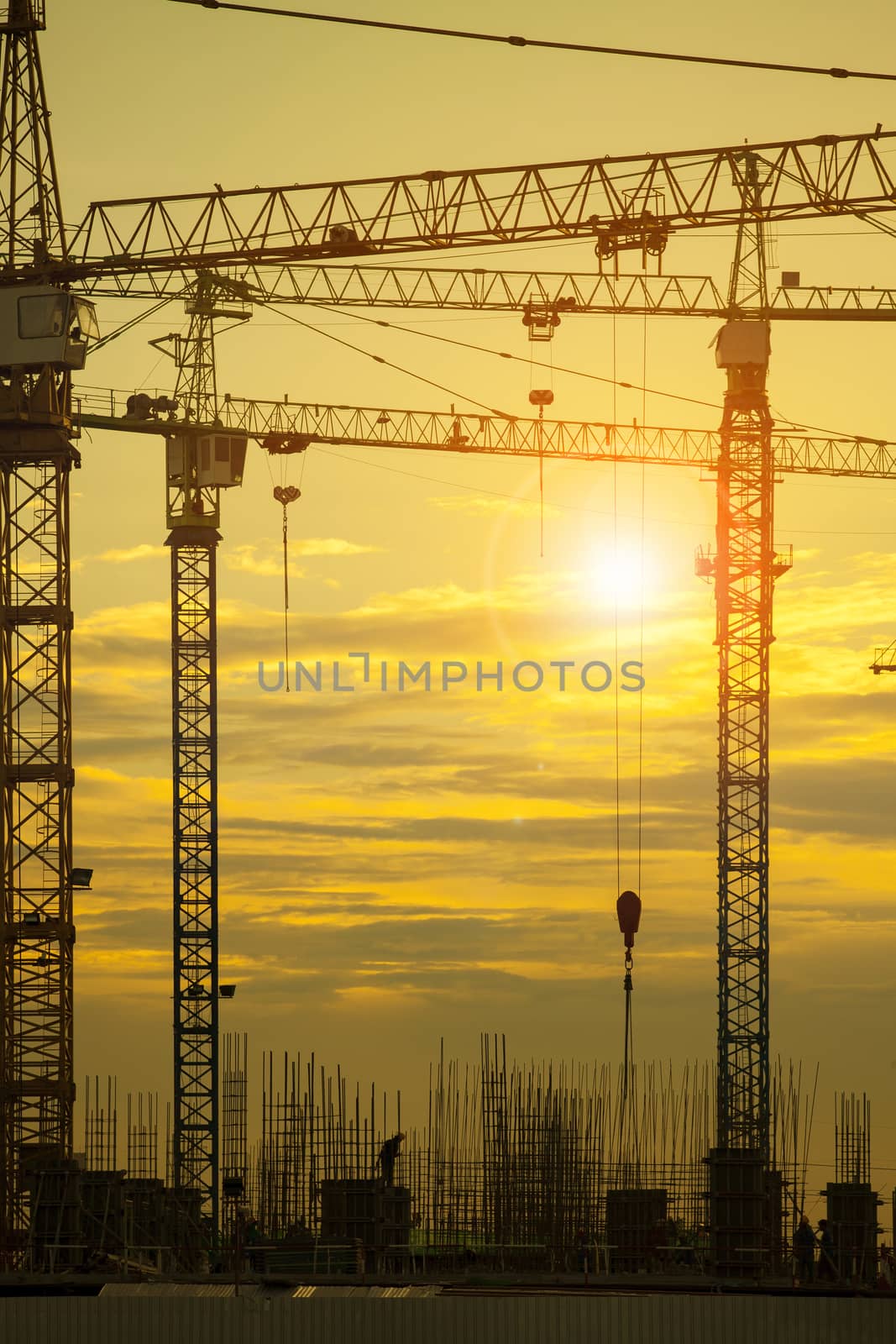 crane of building construction against beautiful dusky sky