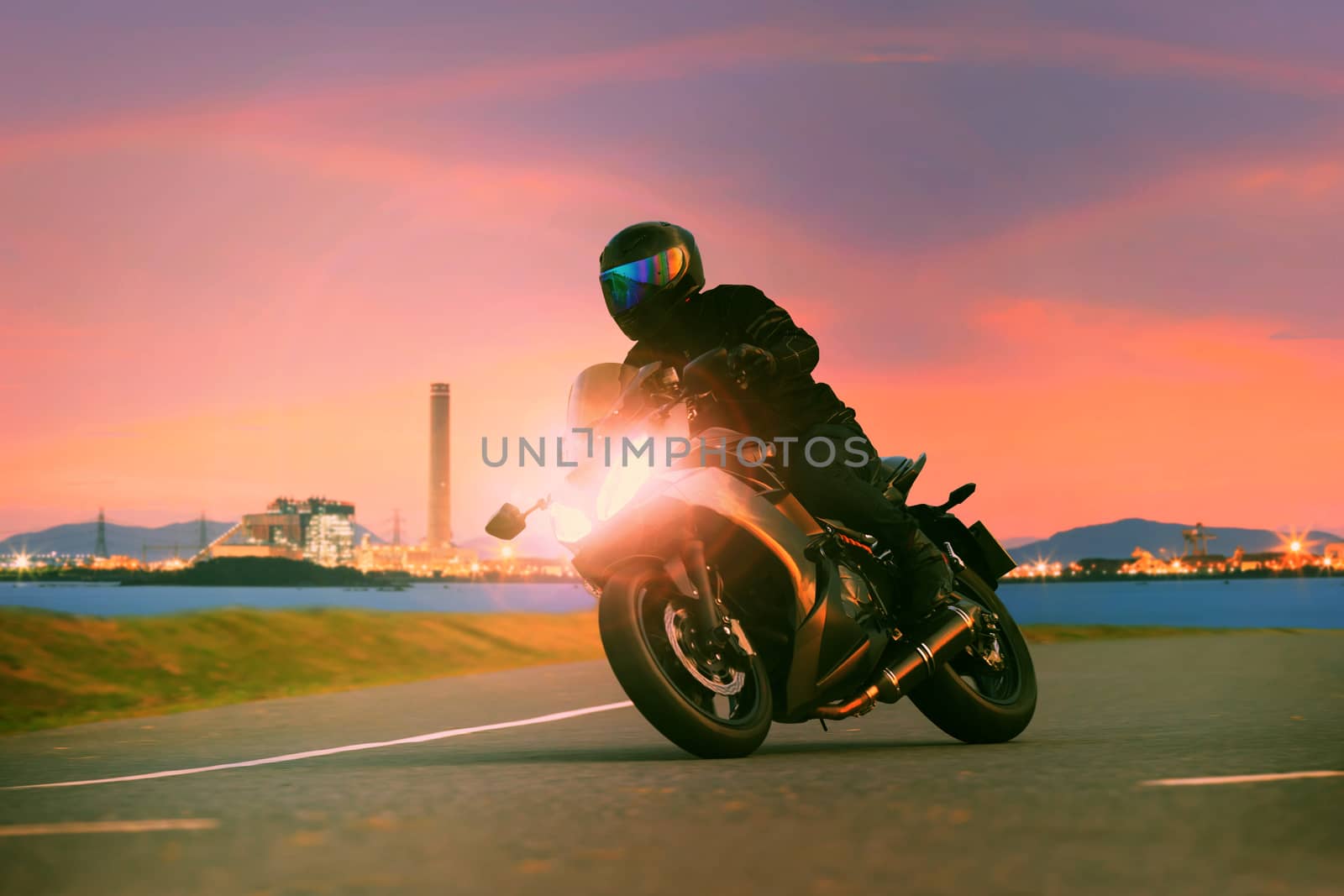 young man riding sport touring motorcycle on asphalt highways ag by khunaspix