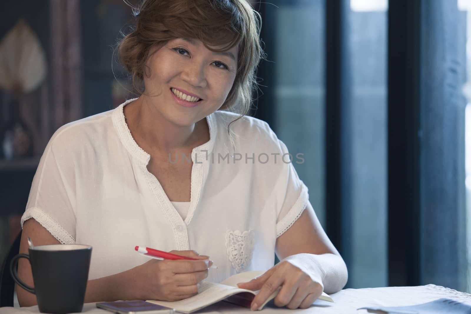 asian woman smiling face ,education and working at home concept relaxing on working table