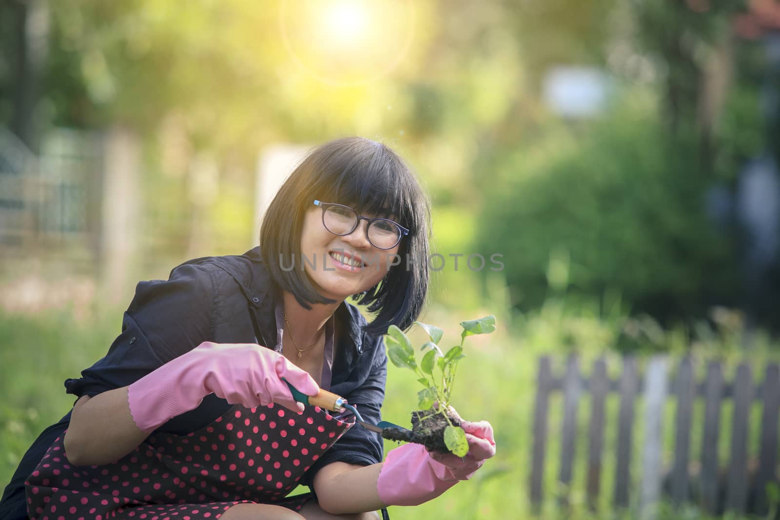 asian woman relaxing happiness emotion planting organic  vegetab by khunaspix