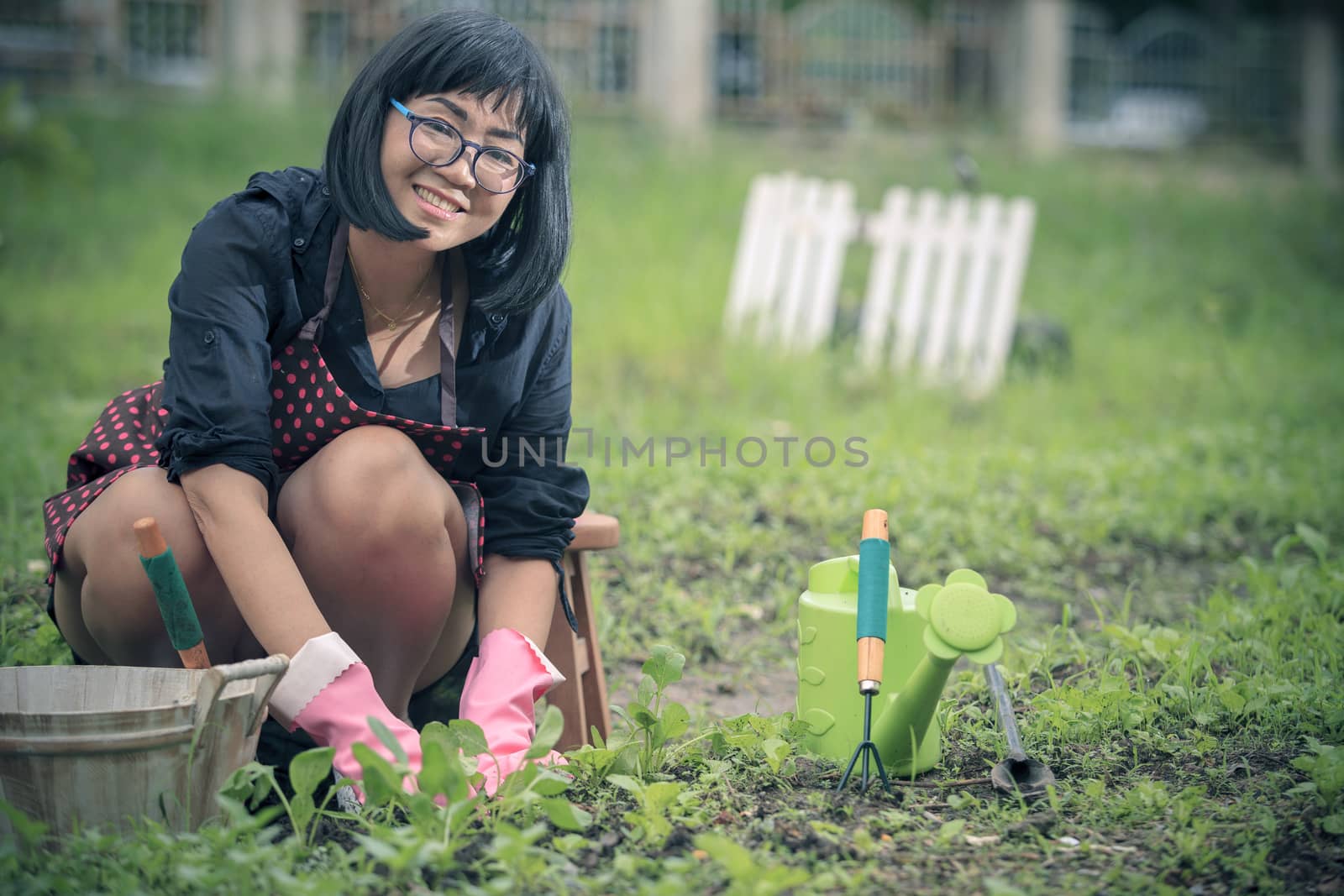 asian woman relaxing happiness emotion planting organic  vegetable in home garden