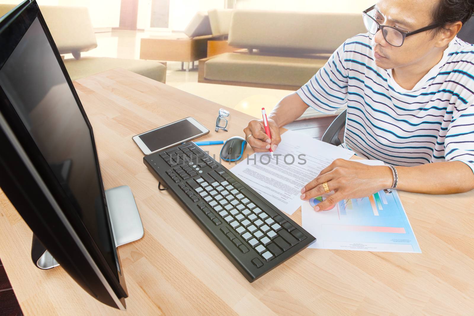man working by computer on table at home living room