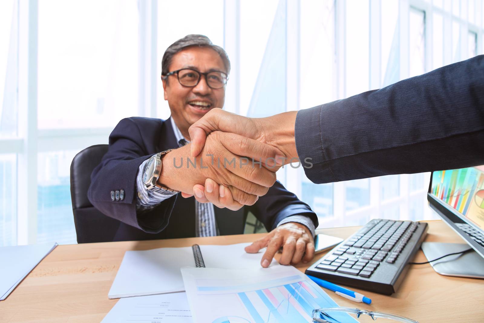 two business man partner shaking hand with happiness emotion after successful of strategy solution planing