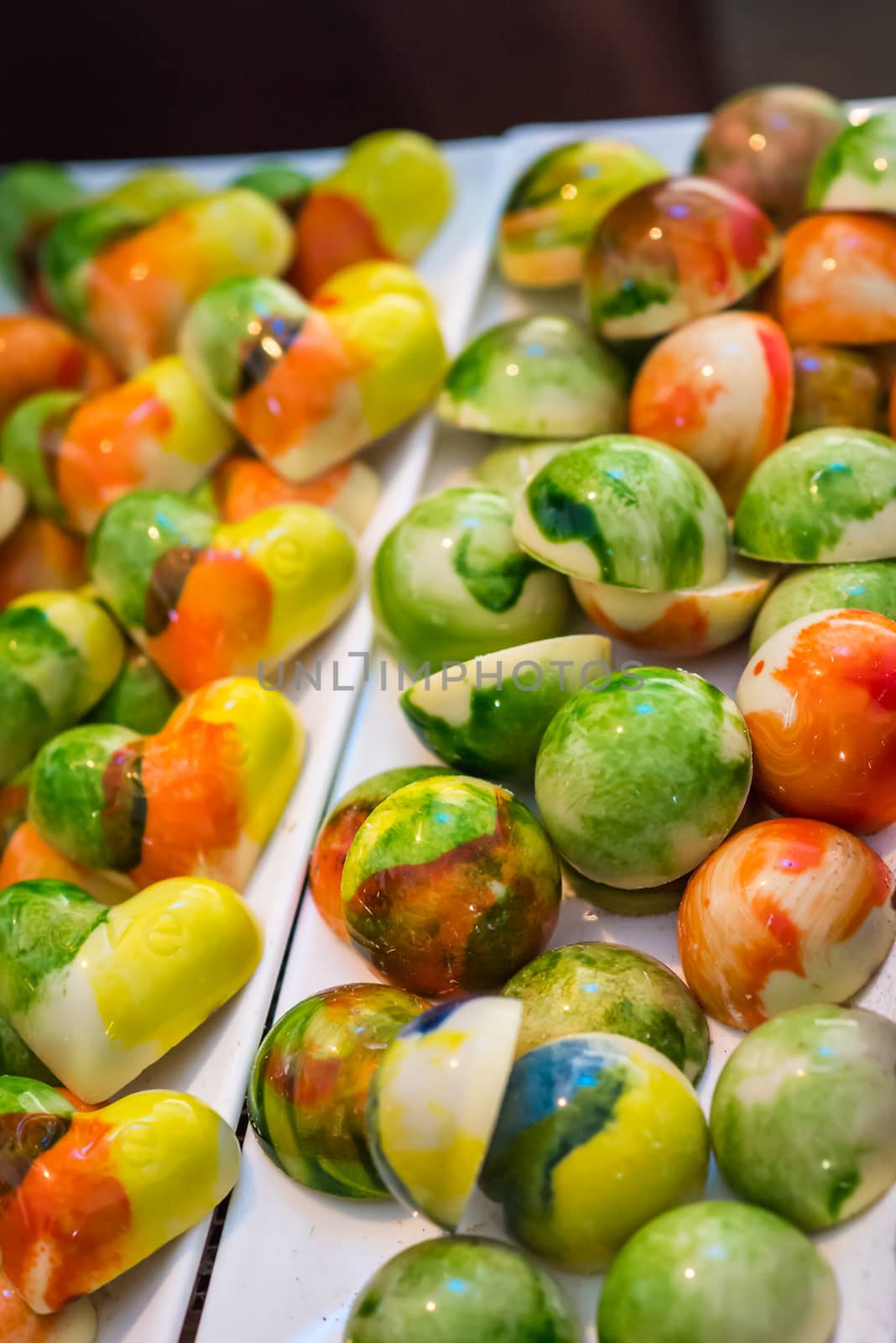 colored tasty candy in the shape of balls and hearts