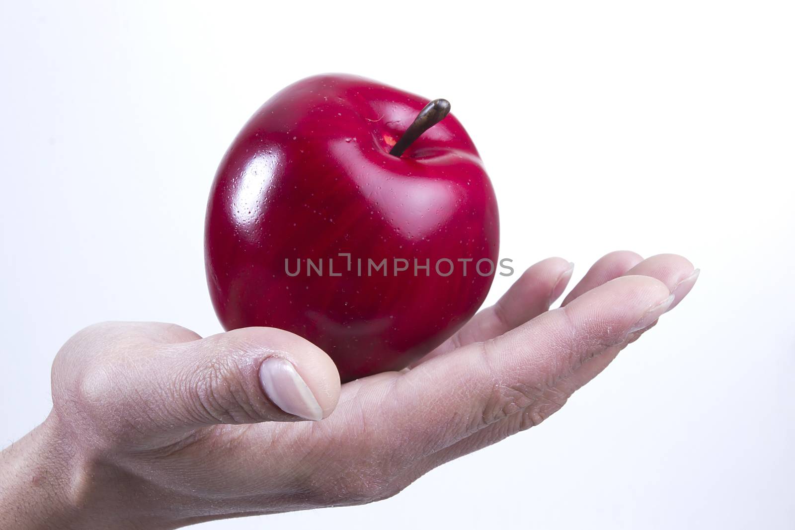 Arm and hand holding an apple by VIPDesignUSA