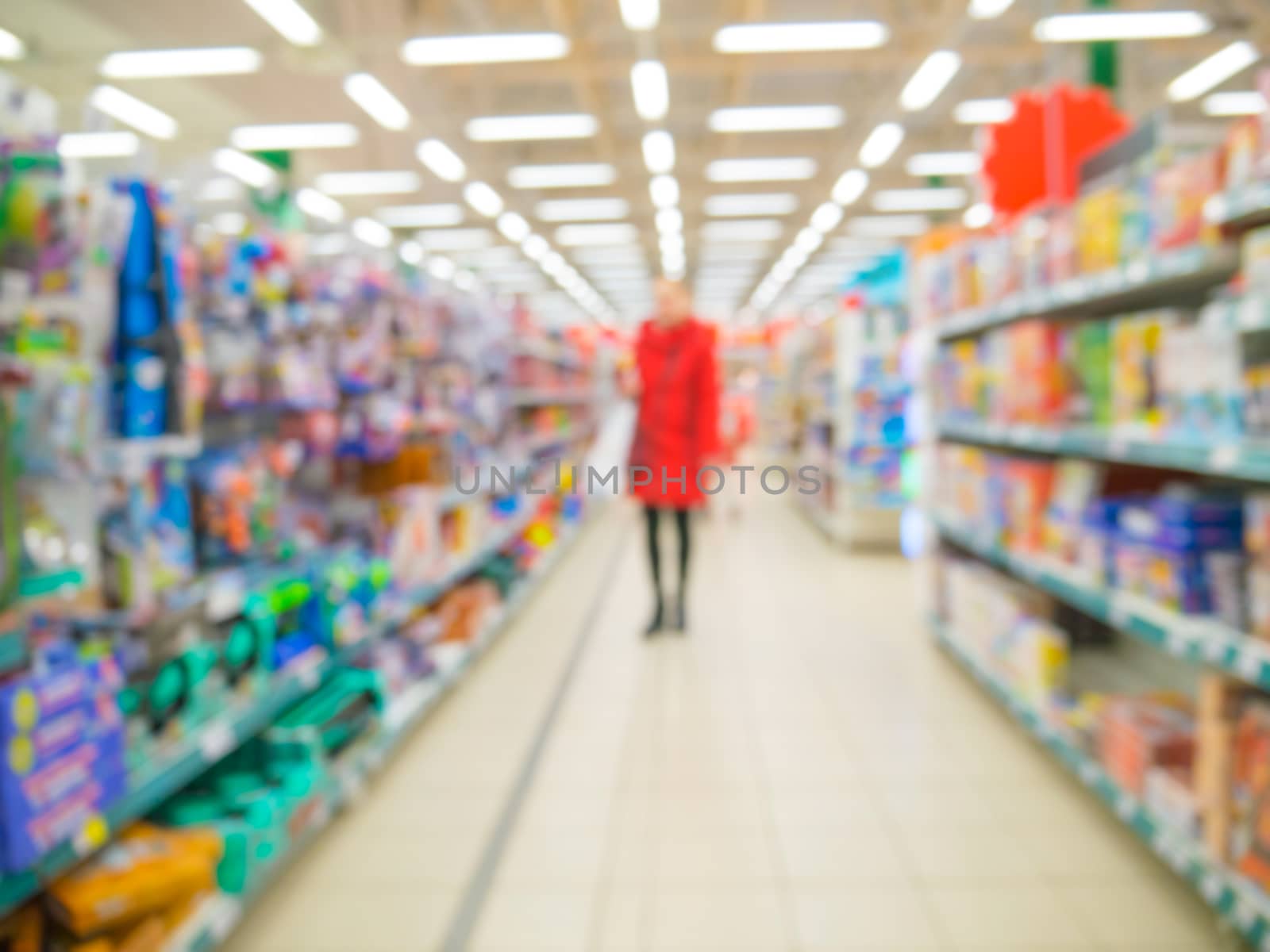 Blurred of kids toy department of store with unrecognizable customer as background